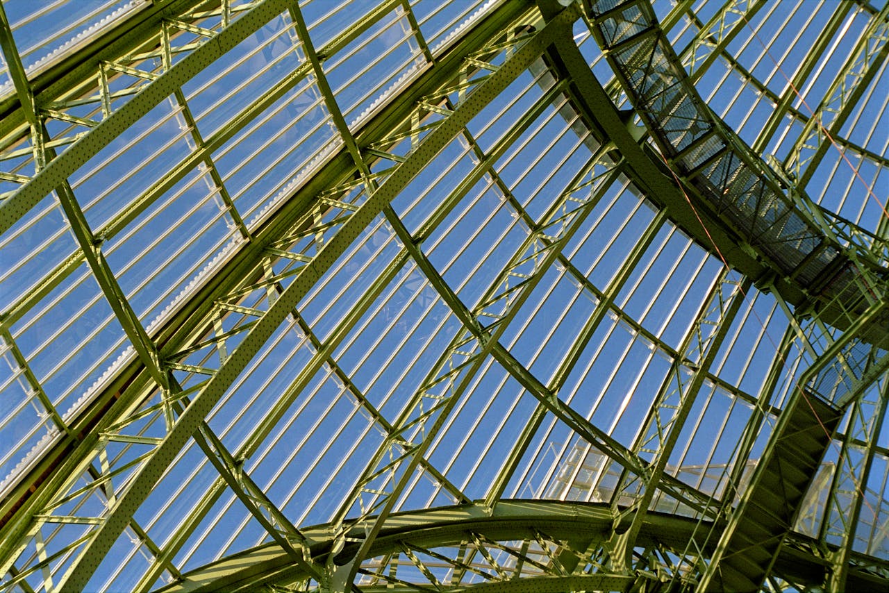 Detailed view of the Grand Palais glass roof structure in Paris, showcasing its architectural elegance.